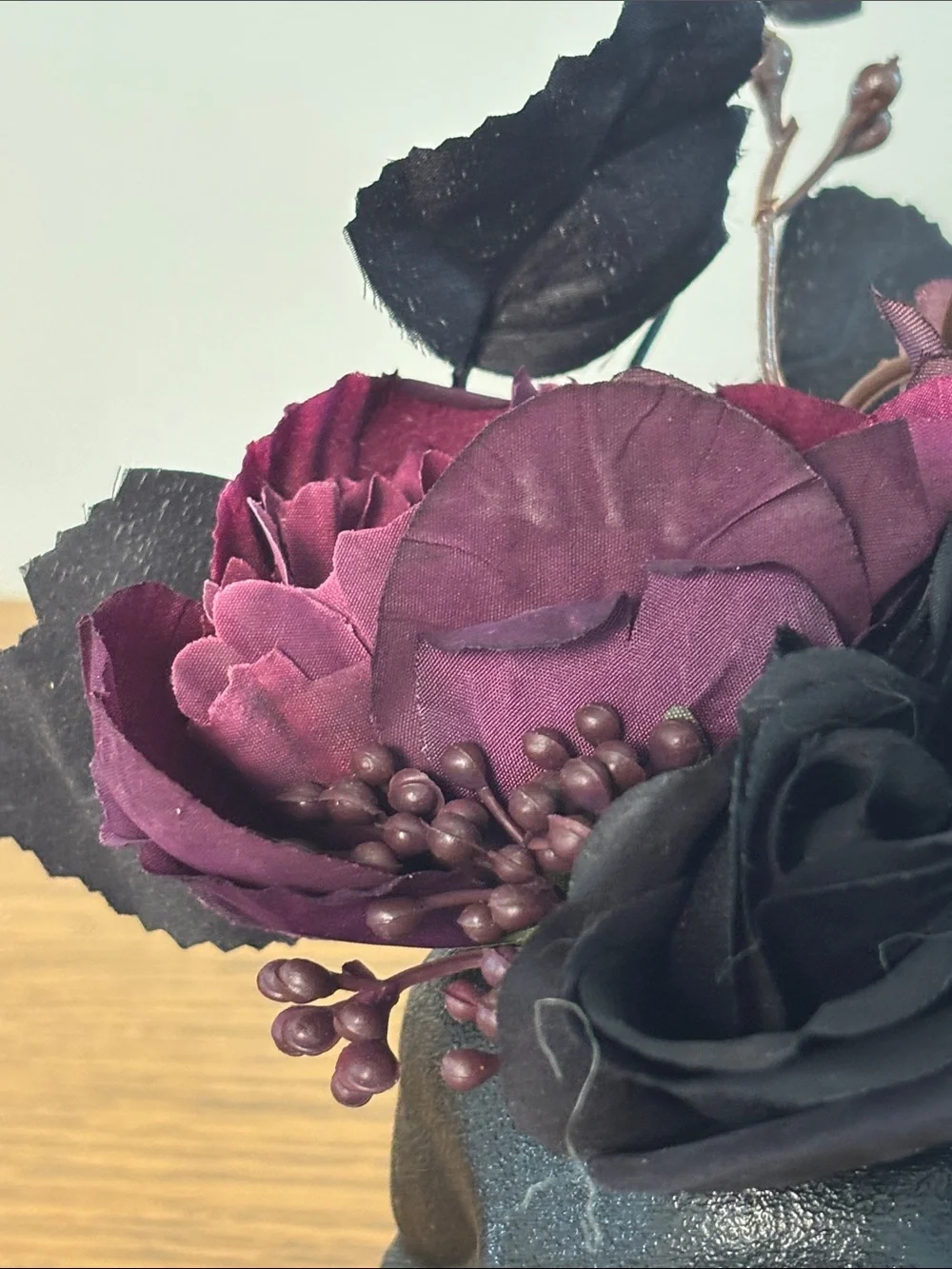 Black Skull Vase with Dark Purple Floral Arrangement